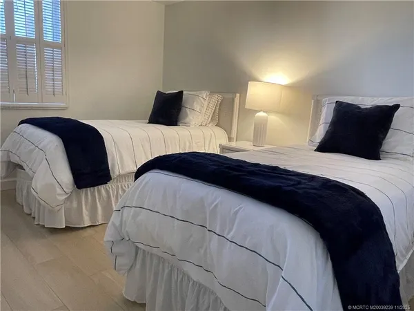 a bedroom with a bed and a night stand