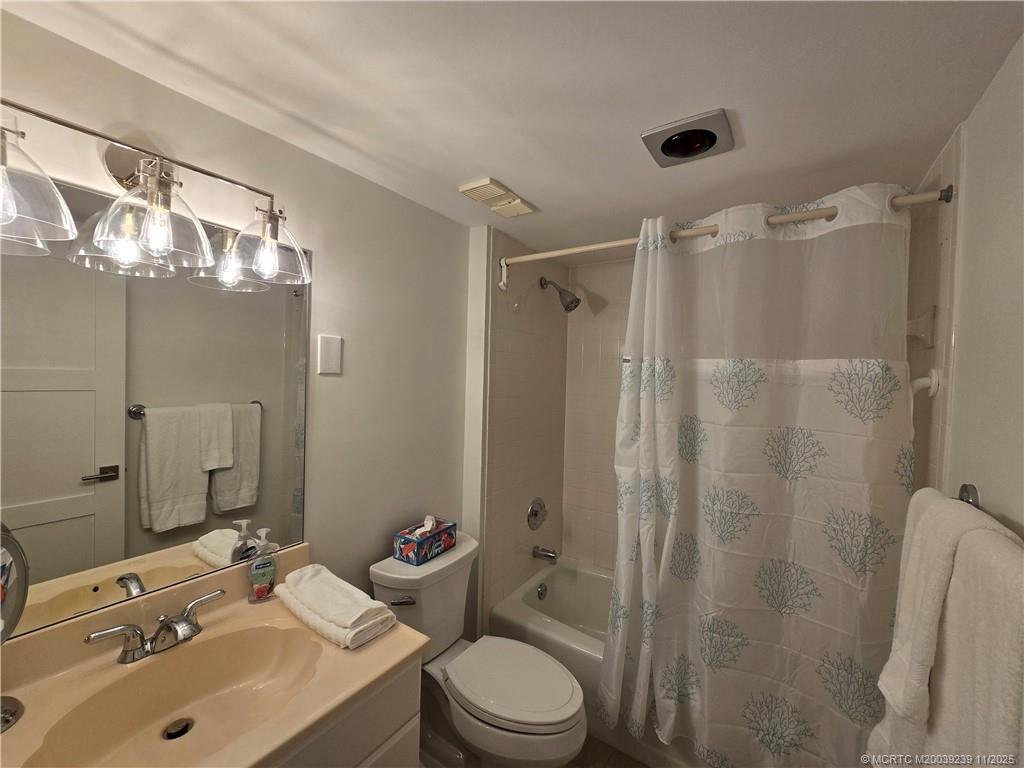 484 Northeast Plantation Road, Unit 4103 Stuart, FL 34996 - Photo 13 of 19 a bathroom with a sink toilet and shower