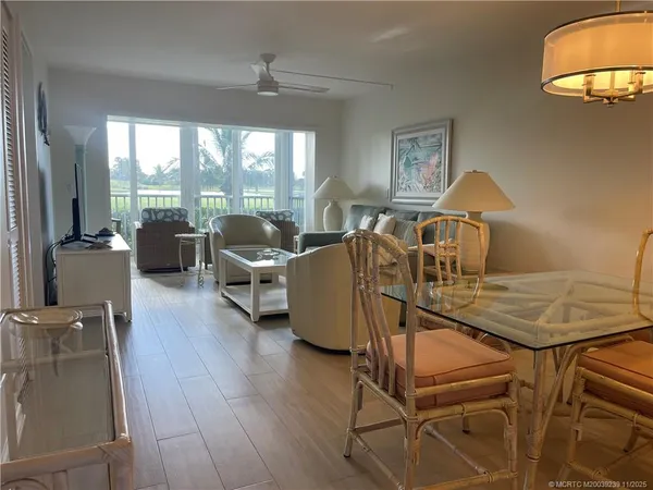 a living room with furniture a window and wooden floor