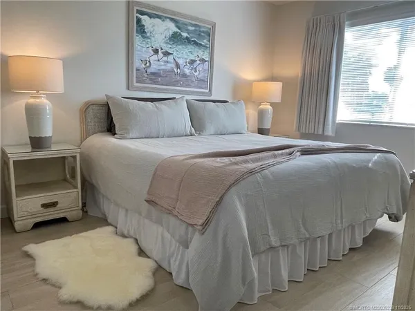 a bedroom with a bed and a night stand