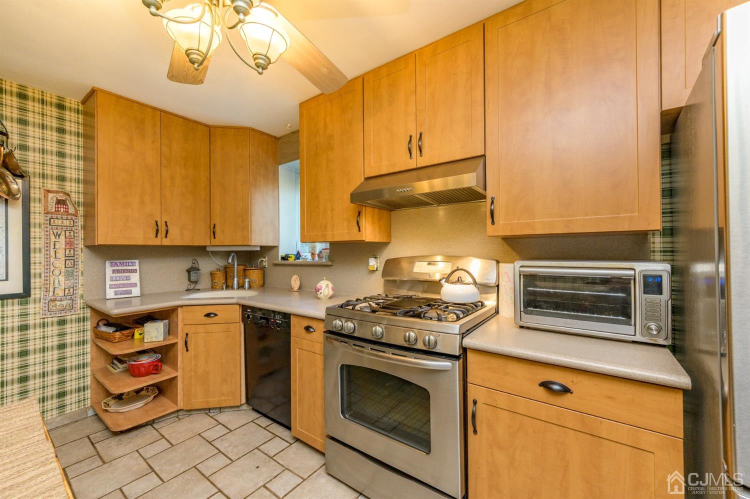 136 Tunison Road New Brunswick, NJ 08901 - Photo 8 of 33 a kitchen with stainless steel appliances a stove a sink and cabinets