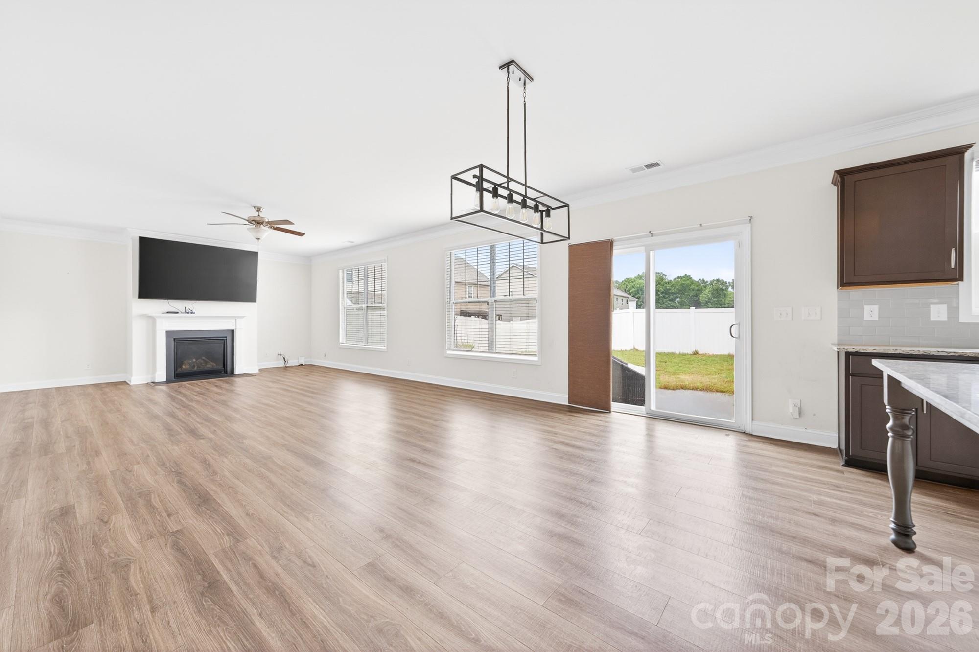 5972 Redwood Pine Road Concord, NC 28027 - Photo 14 of 37 a view of empty room with wooden floor and fireplace