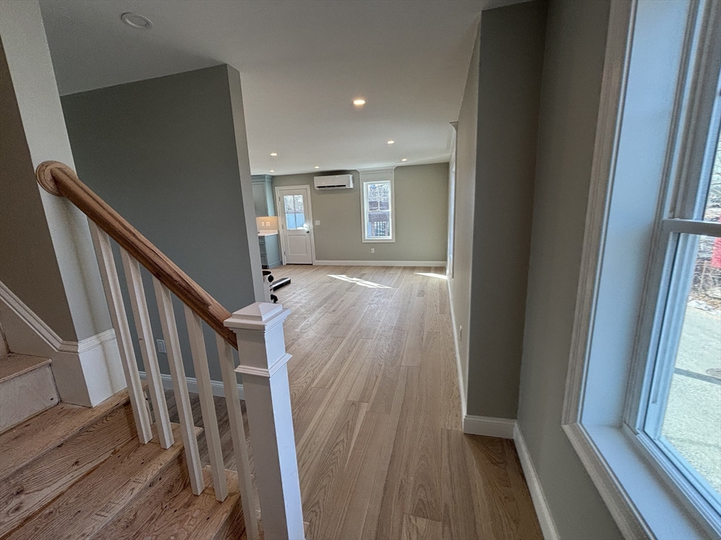 46 Holt Road, Unit A Bourne, MA 02532 - Photo 12 of 28 a view of livingroom with wooden floor and stairs