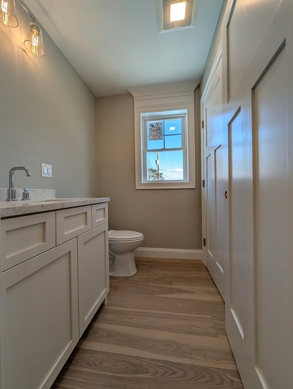 46 Holt Road, Unit A Bourne, MA 02532 - Photo 17 of 28 a bathroom with a toilet sink and mirror