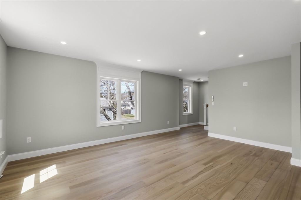 46 Holt Road, Unit A Bourne, MA 02532 - Photo 23 of 28 an empty room with wooden floor and window