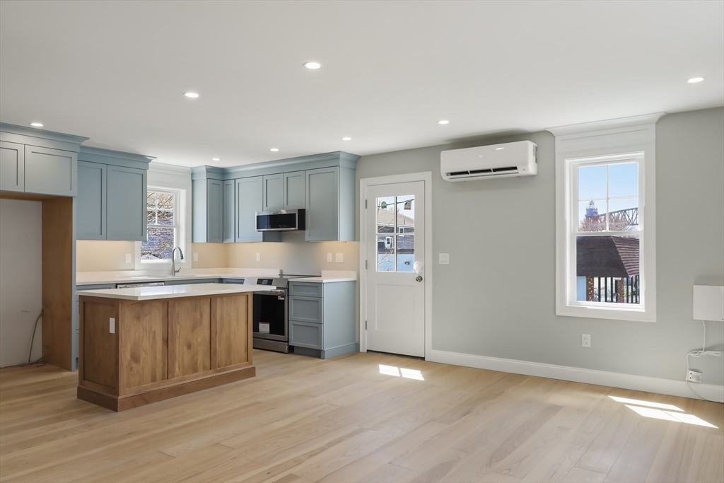 46 Holt Road, Unit A Bourne, MA 02532 - Photo 6 of 28 a kitchen with stainless steel appliances granite countertop a stove a sink and a refrigerator