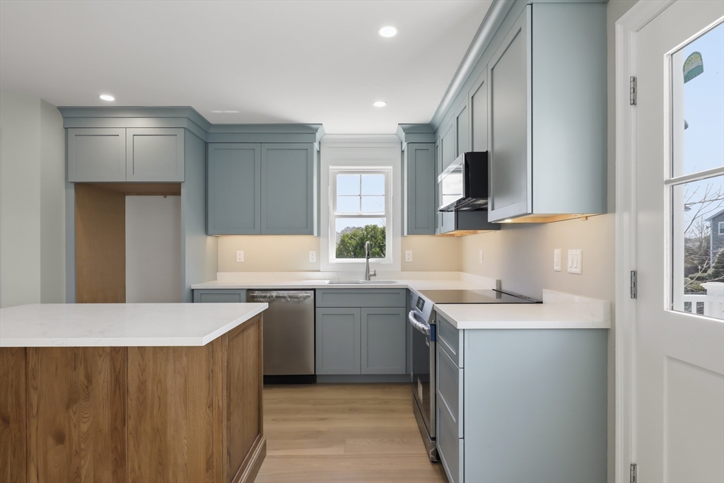 46 Holt Road, Unit A Bourne, MA 02532 - Photo 7 of 28 a kitchen with a sink a stove and cabinets