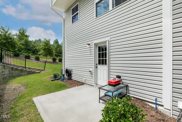 a view of a patio with couches chairs and potted plants