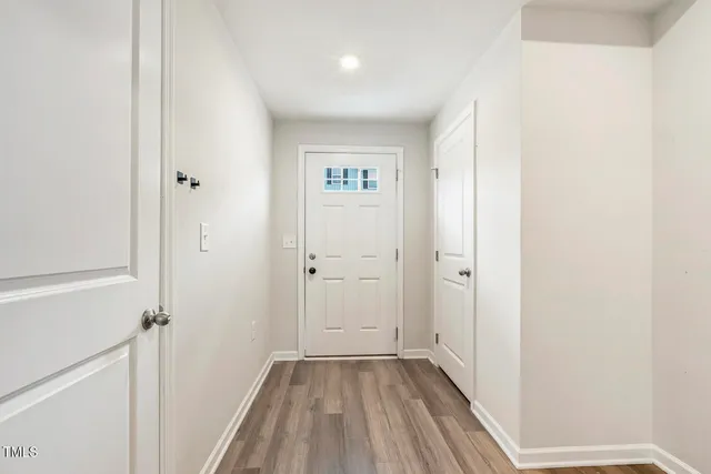 a view of a hallway with wooden floor