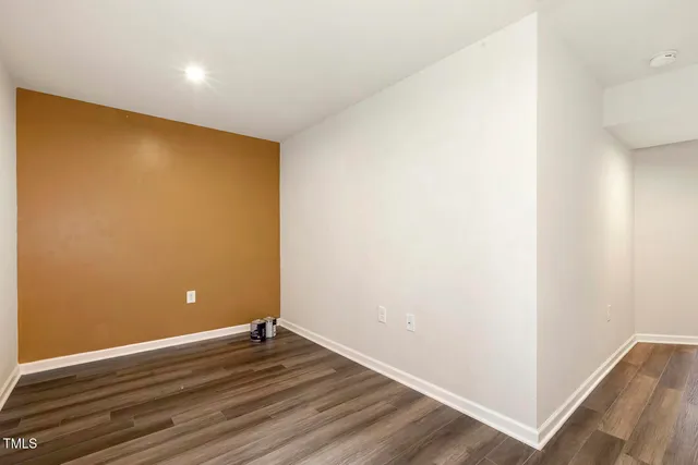 a view of room with wooden floor