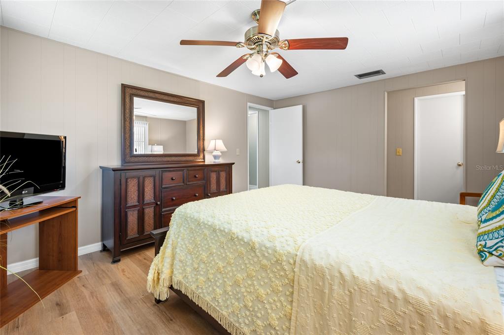5751 Hyacinth Road Venice, FL 34293 - Photo 20 of 44 a bedroom with a bed and a flat screen tv
