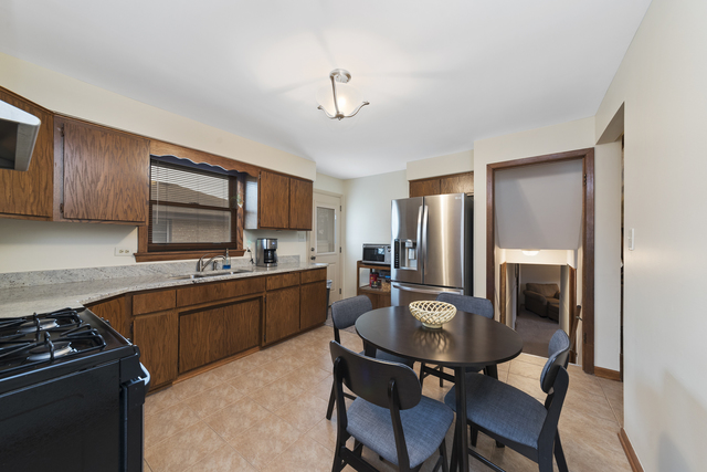 10700 Austin Avenue Chicago Ridge, IL 60415 - Photo 6 of 19 a kitchen with stainless steel appliances granite countertop a stove refrigerator sink and cabinets