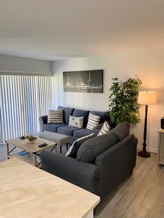 a living room with furniture and a lamp