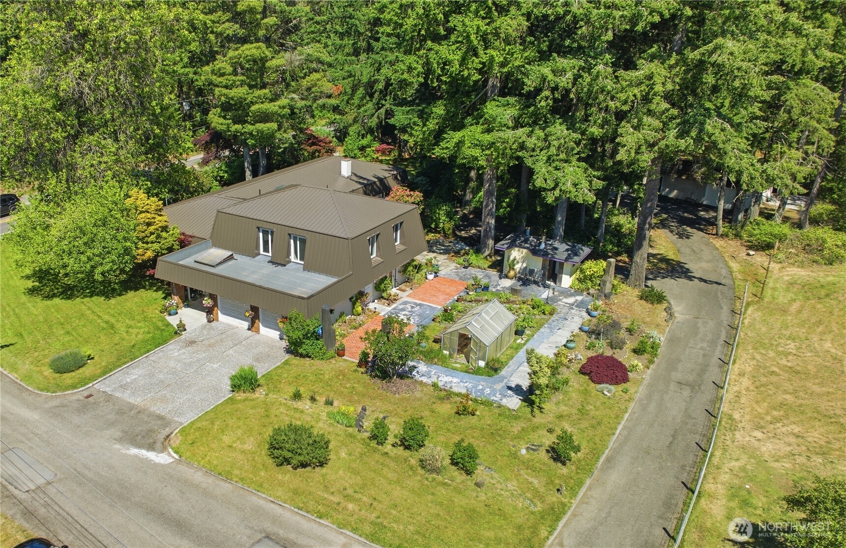 3050 Southeast Mullenix Road Port Orchard, WA 98367 - Photo 2 of 40 an aerial view of a house with a yard basket ball court and outdoor seating