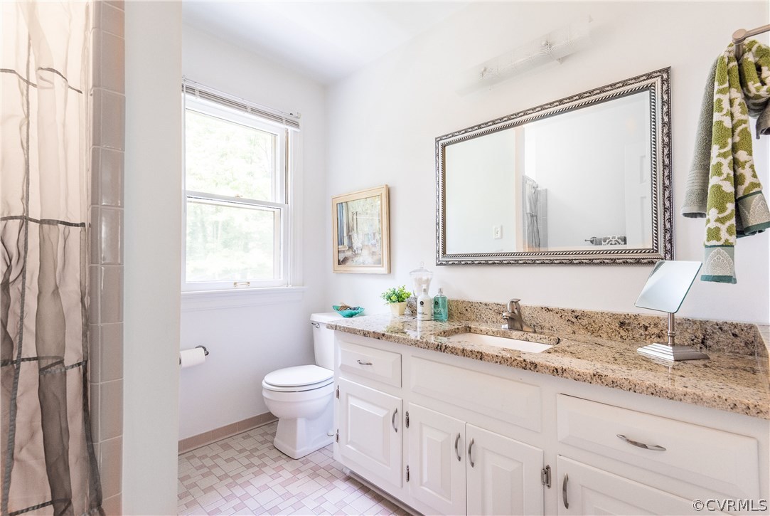 14008 Walnut Creek Road Midlothian, VA 23112 - Photo 24 of 34 a bathroom with a granite countertop sink a toilet and a mirror