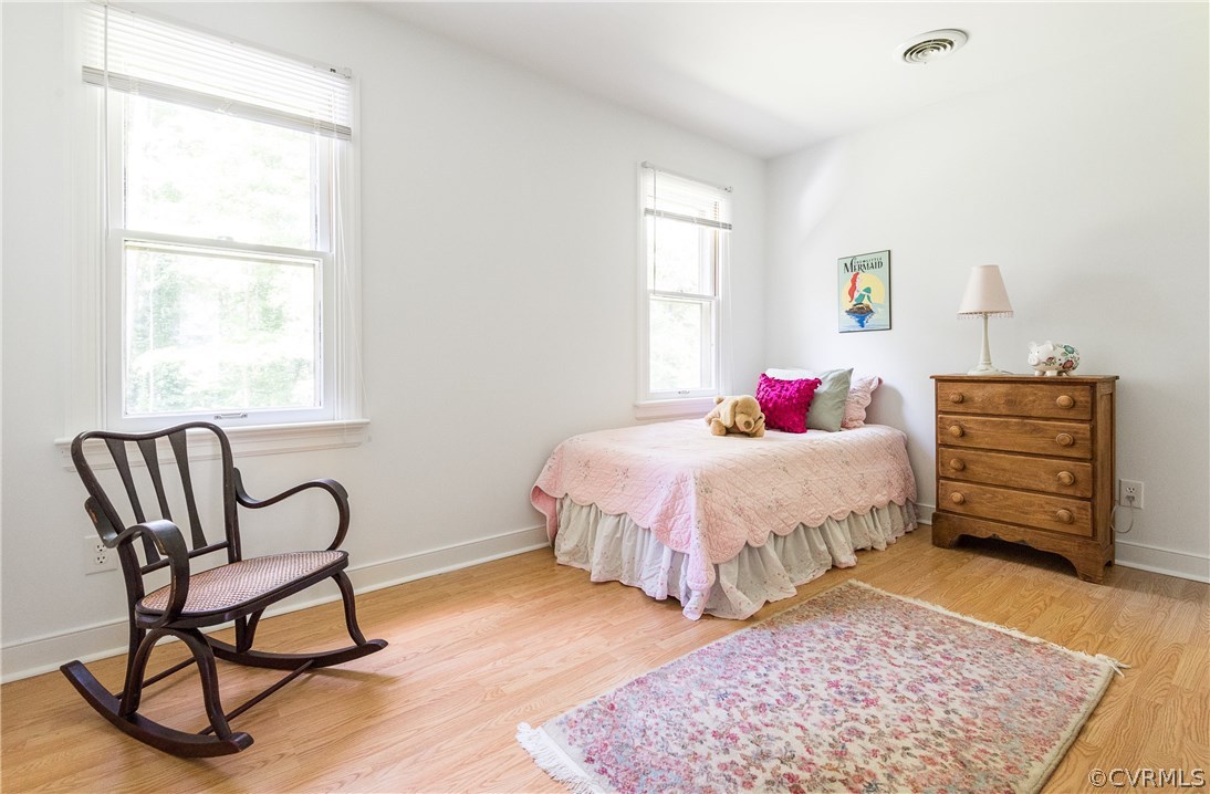 14008 Walnut Creek Road Midlothian, VA 23112 - Photo 28 of 34 a spacious bedroom with a bed a dresser and chair