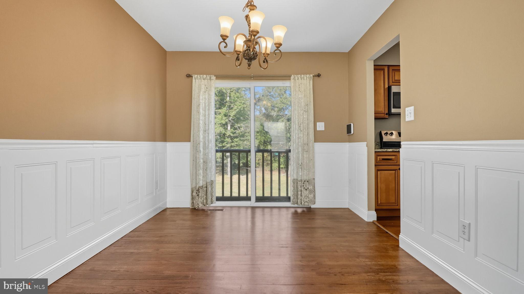 8136 Comet Drive Fort Washington, MD 20744 - Photo 13 of 49 wooden floor in an empty room with a window