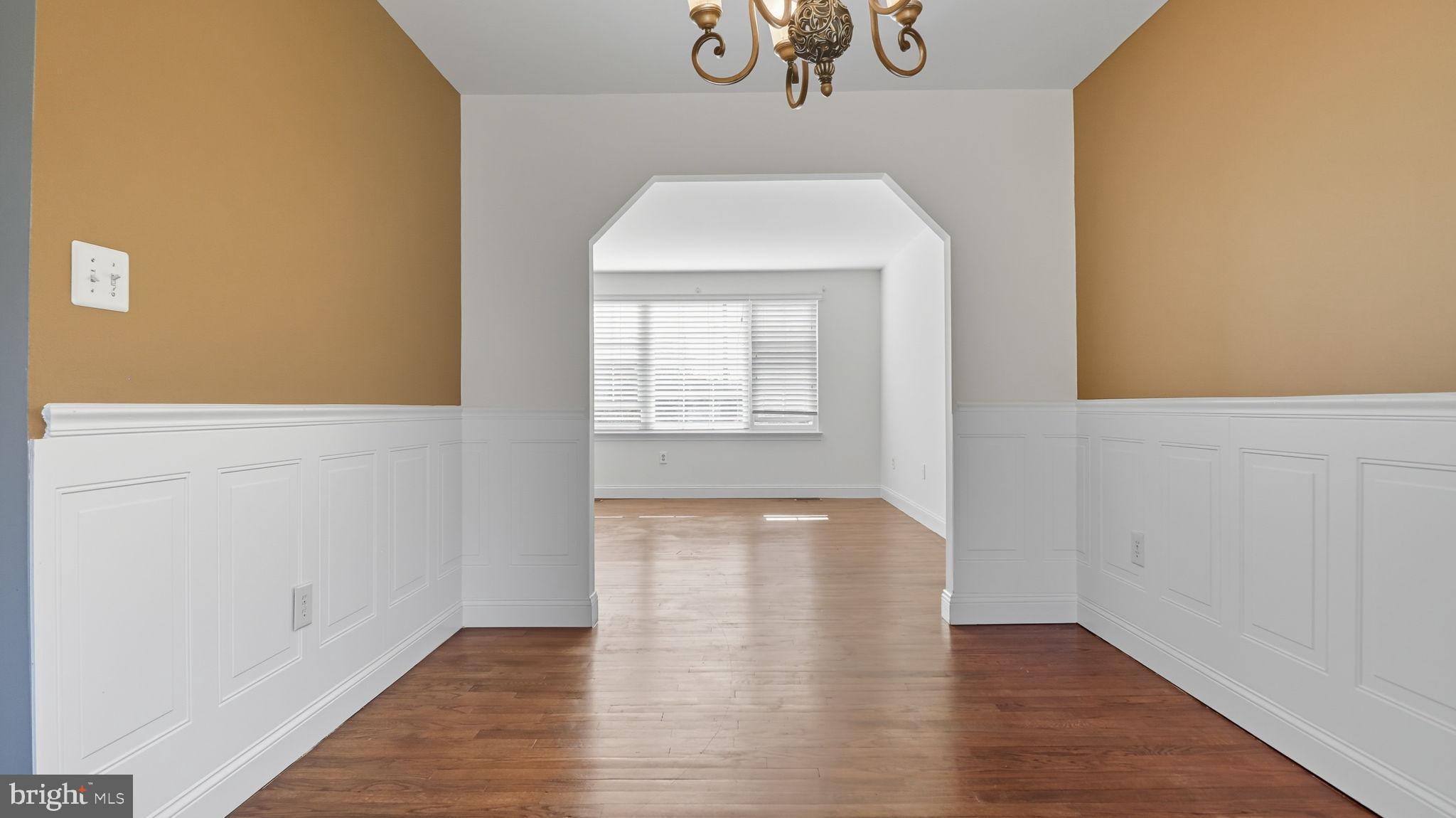 8136 Comet Drive Fort Washington, MD 20744 - Photo 14 of 49 a view of an empty room with wooden floor and a window