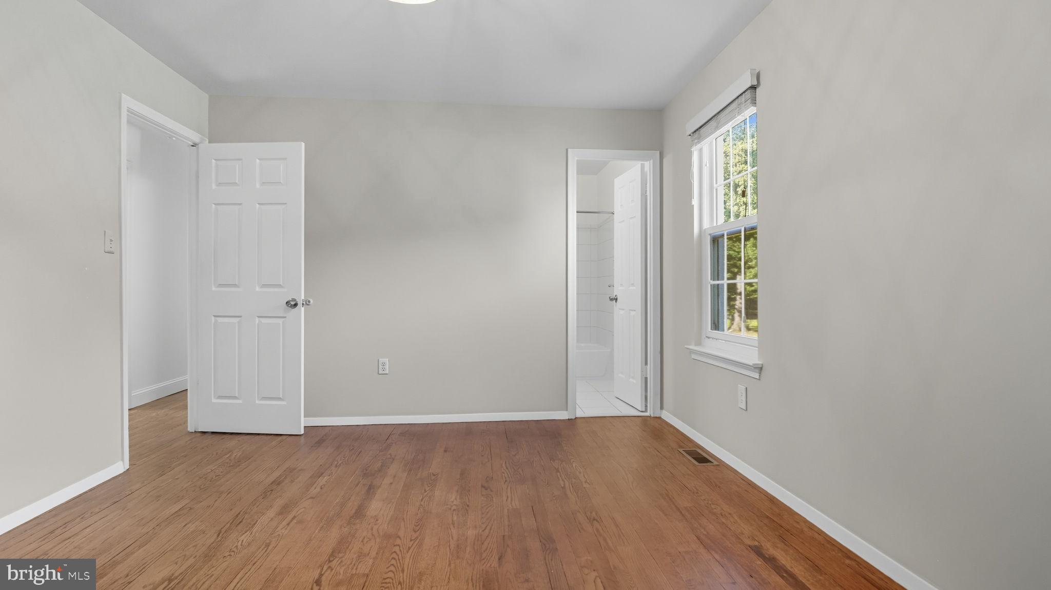 8136 Comet Drive Fort Washington, MD 20744 - Photo 26 of 49 an empty room with wooden floor and windows