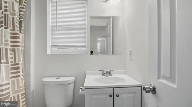 a bathroom with a sink toilet and mirror