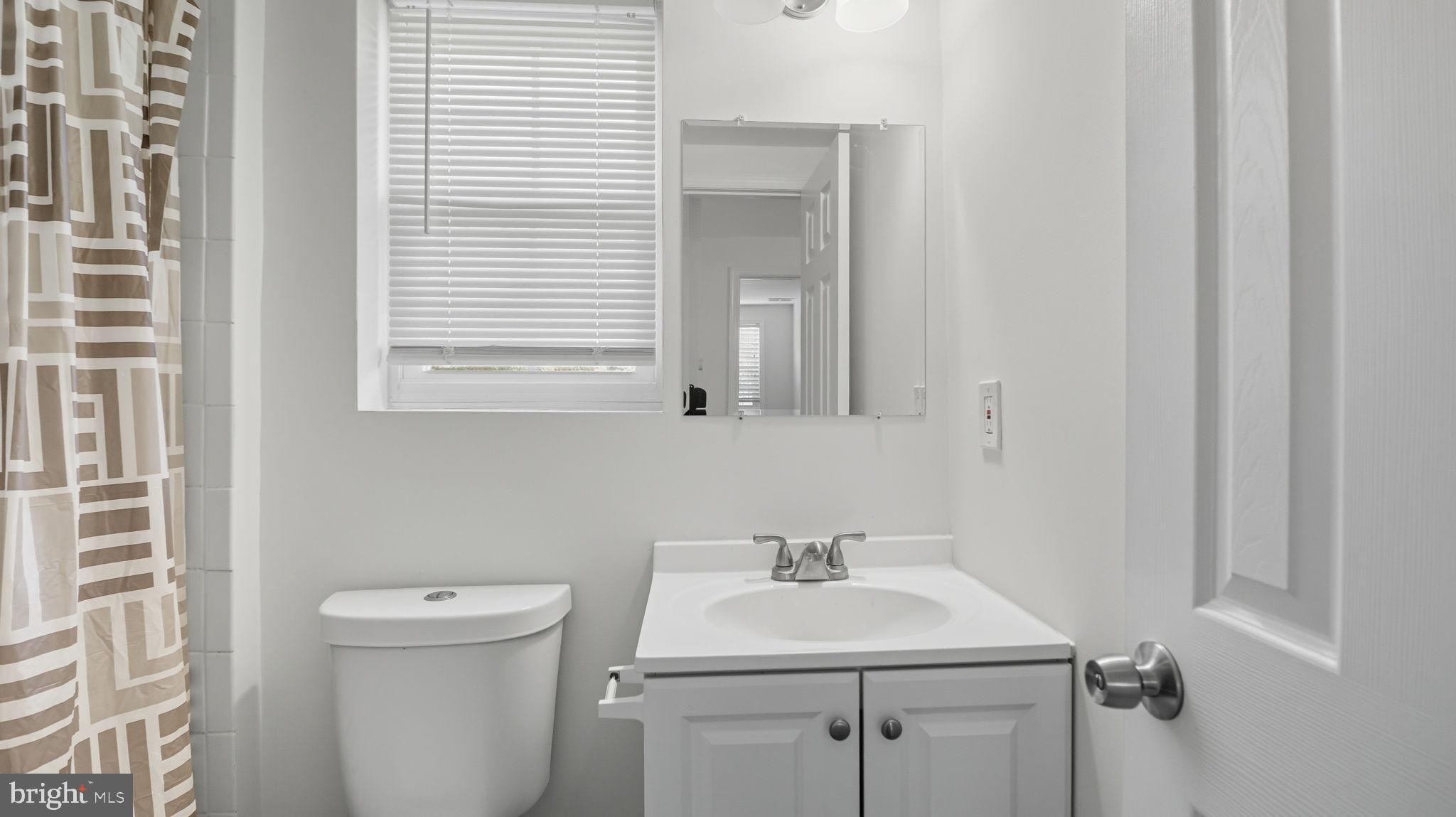 8136 Comet Drive Fort Washington, MD 20744 - Photo 29 of 49 a bathroom with a sink toilet and mirror