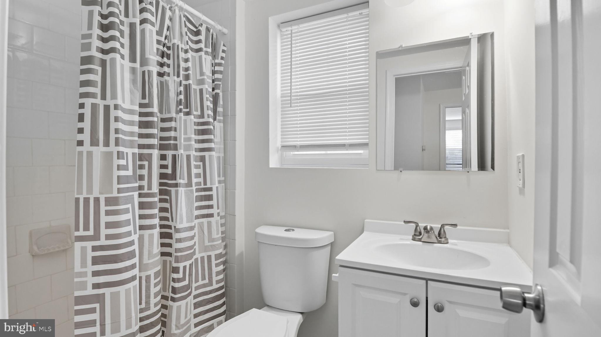 8136 Comet Drive Fort Washington, MD 20744 - Photo 30 of 49 a bathroom with a sink a toilet and a mirror