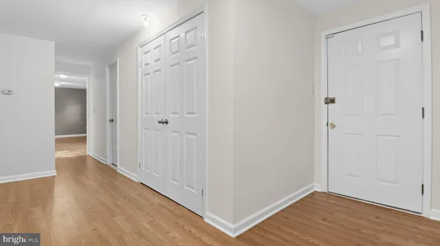 a view of a hallway with wooden floor