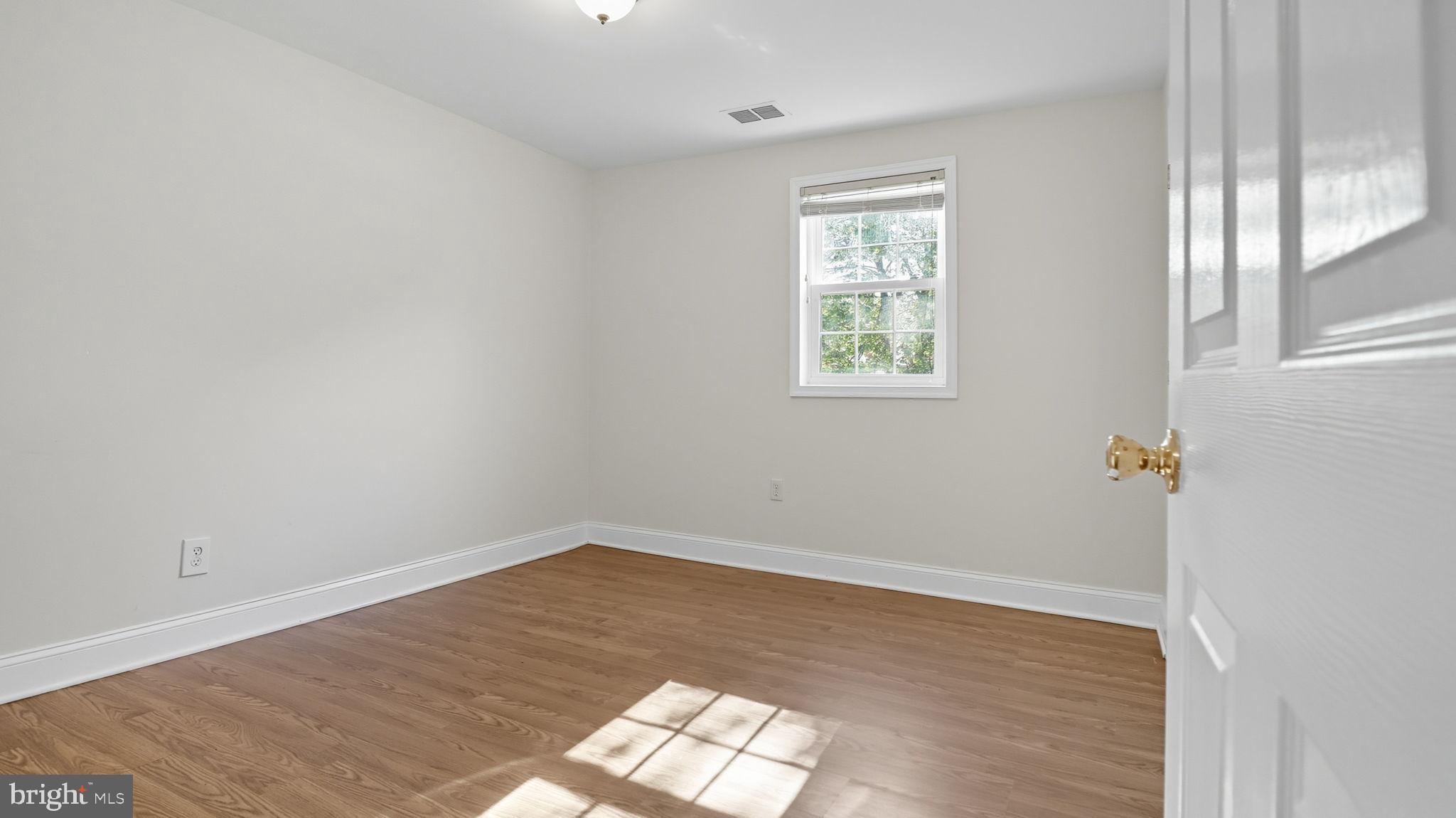 8136 Comet Drive Fort Washington, MD 20744 - Photo 34 of 49 an empty room with wooden floor and windows