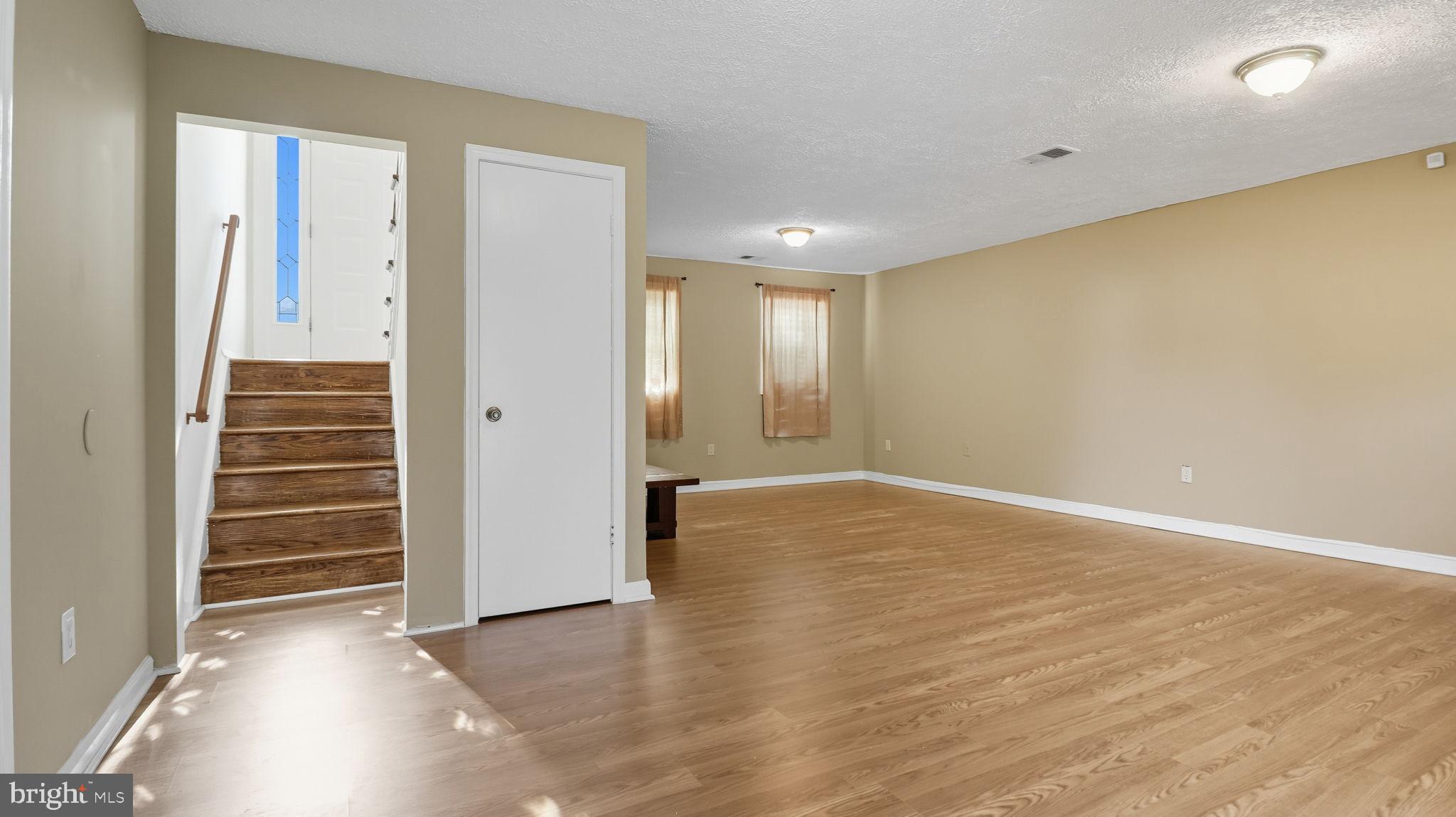 8136 Comet Drive Fort Washington, MD 20744 - Photo 37 of 49 an empty room with wooden floor and windows