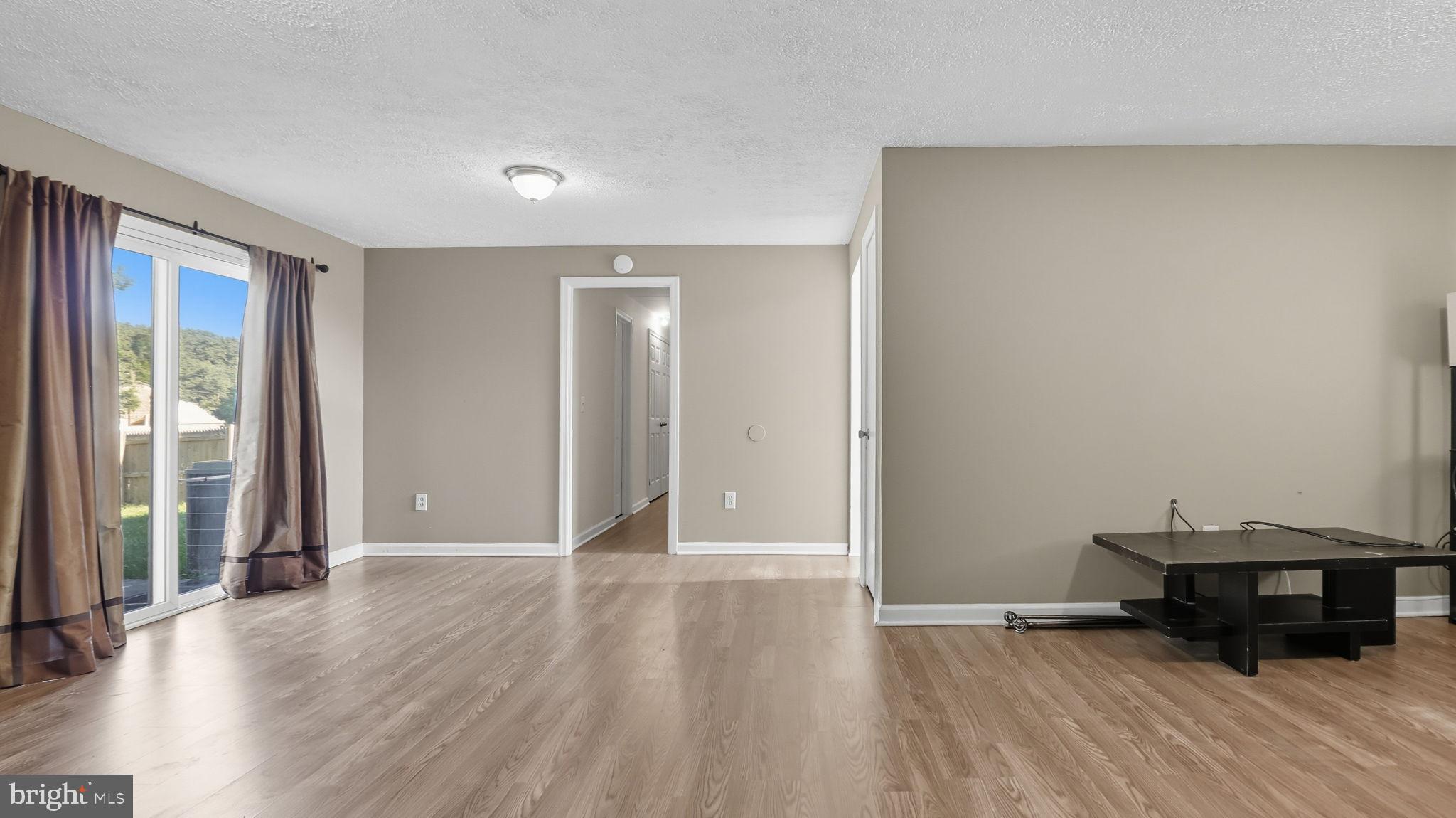 8136 Comet Drive Fort Washington, MD 20744 - Photo 40 of 49 an empty room with wooden floor and a window