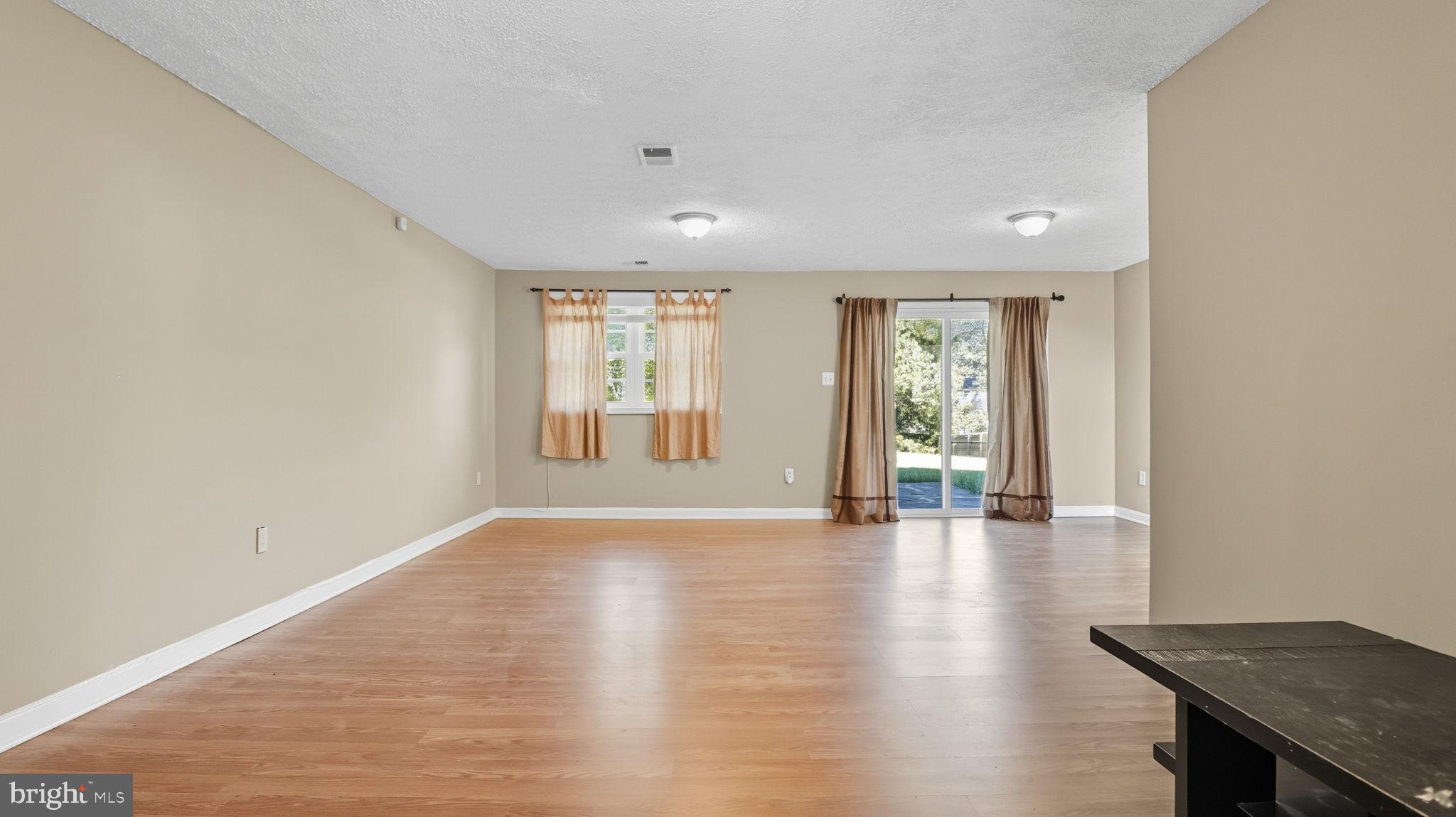 8136 Comet Drive Fort Washington, MD 20744 - Photo 42 of 49 a view of an empty room with wooden floor and a window