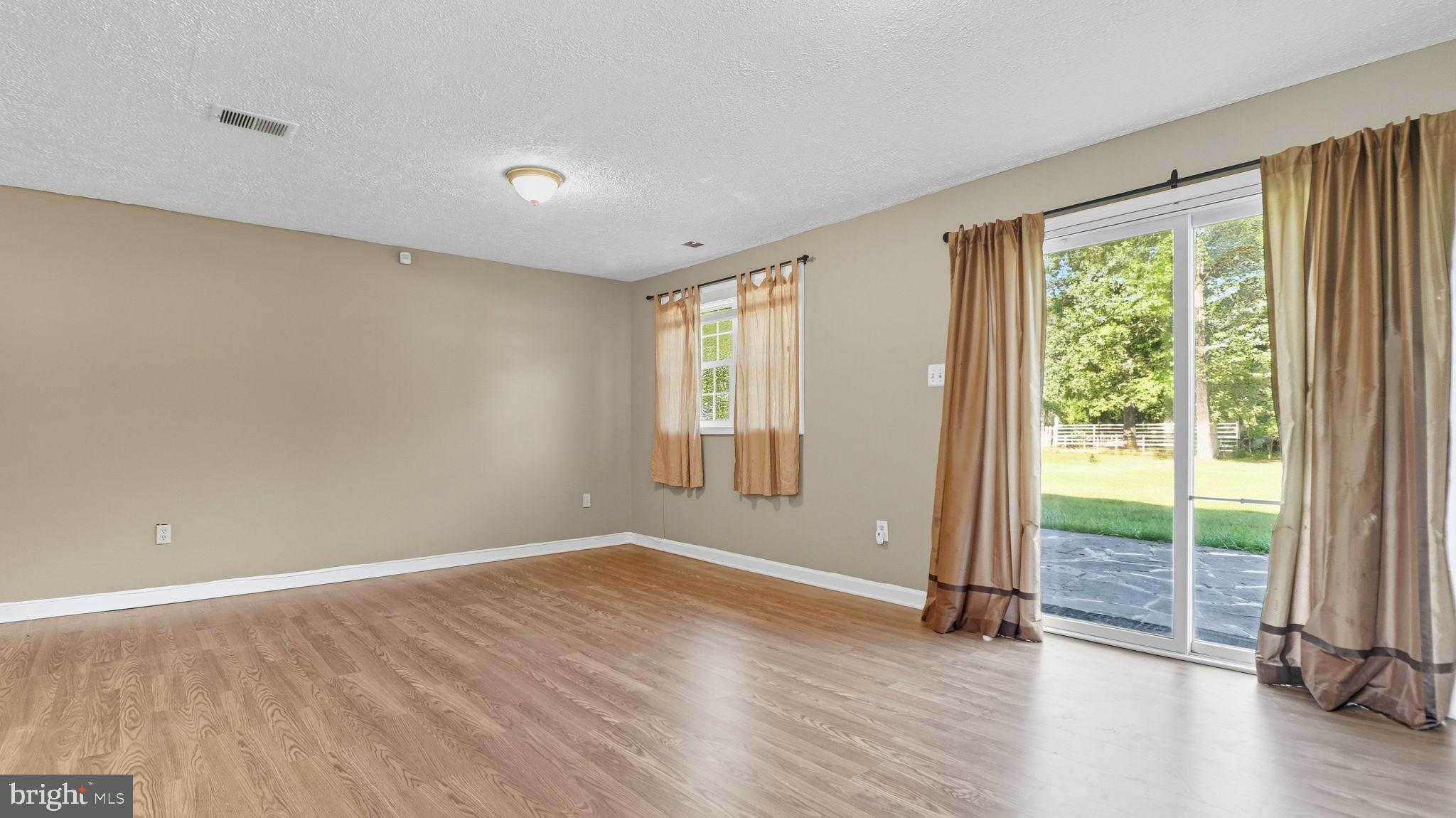 8136 Comet Drive Fort Washington, MD 20744 - Photo 43 of 49 an empty room with wooden floor and windows