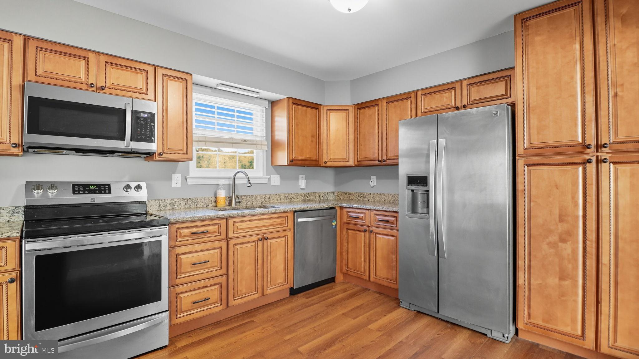 8136 Comet Drive Fort Washington, MD 20744 - Photo 10 of 49 a kitchen with stainless steel appliances a stove a sink and a microwave
