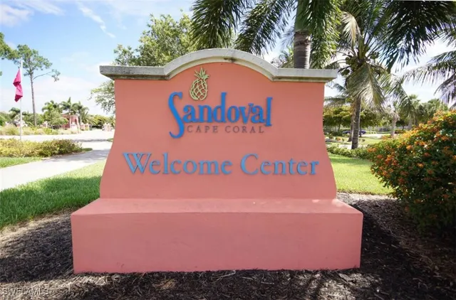 a building with a sign board and yard