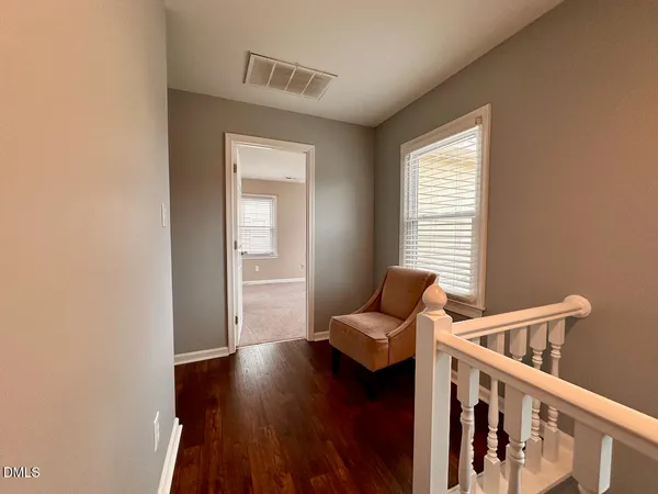 an empty room with a empty space and windows