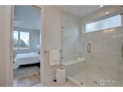 a en suite bathroom with a tub sink and mirror