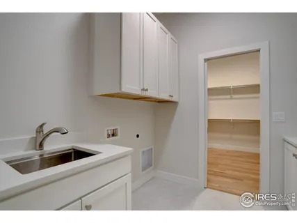 a kitchen with white cabinets and a sink