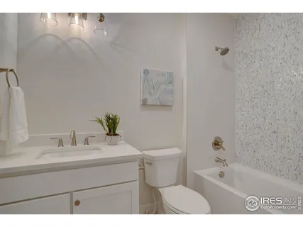 a bathroom with a sink a toilet and bathtub