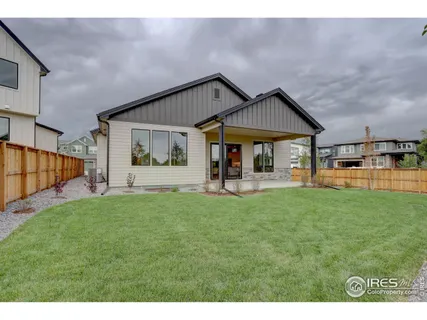 a view of a house with backyard and porch