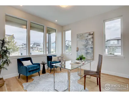 a living room with furniture a table and a large window