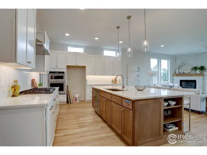 a kitchen with stainless steel appliances granite countertop a sink a stove and a refrigerator