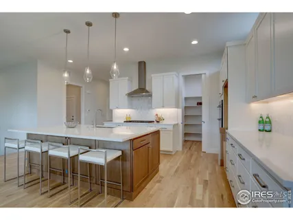 a kitchen with kitchen island a sink stove and wooden cabinets