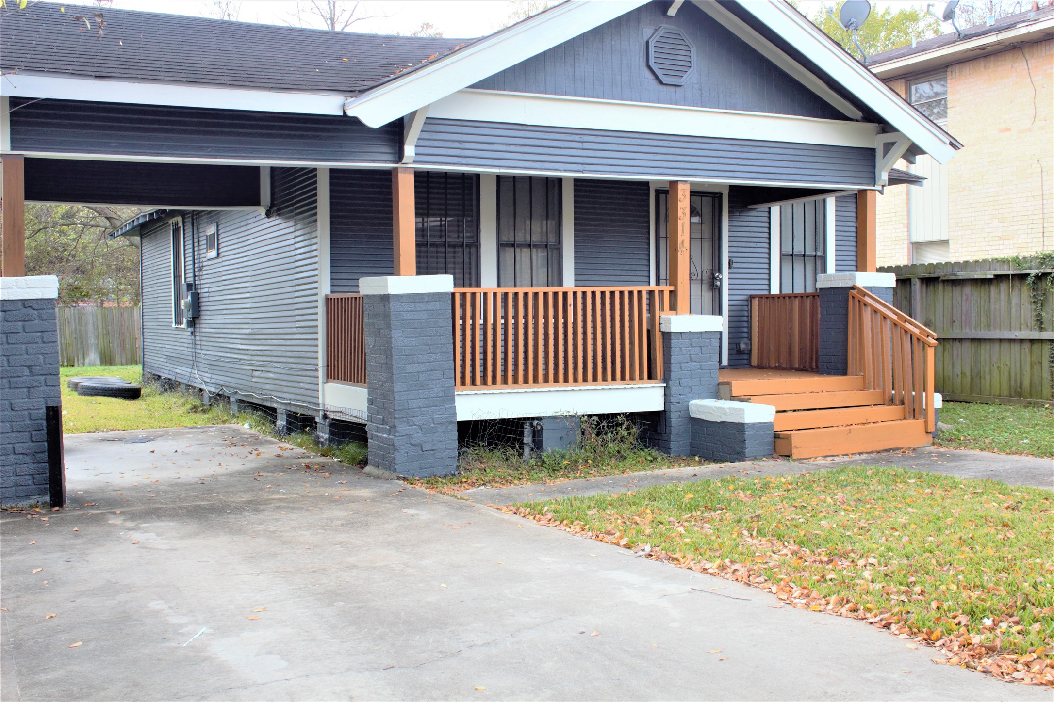 3314 Holman Street Houston, TX 77004 - Photo 2 of 7 a view of a small house and wooden fence