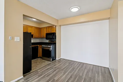a kitchen with a refrigerator and a stove top oven