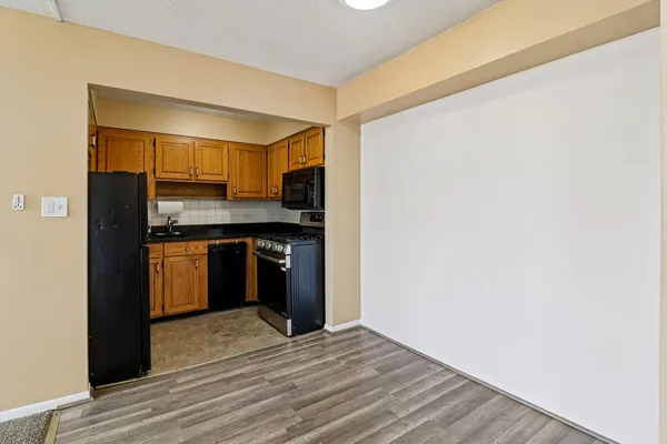 a kitchen with a refrigerator and a stove