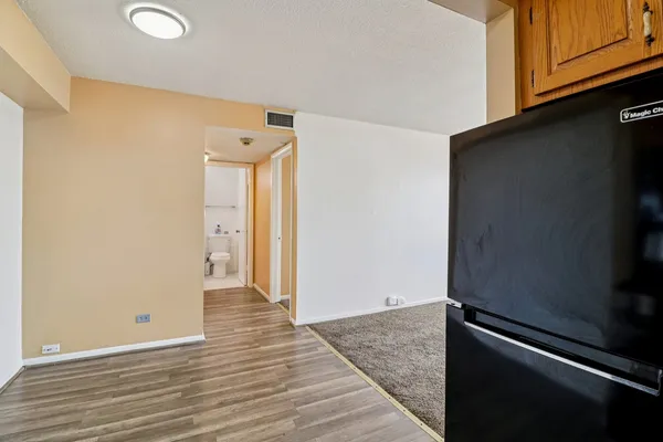an empty room with wooden floor and closet