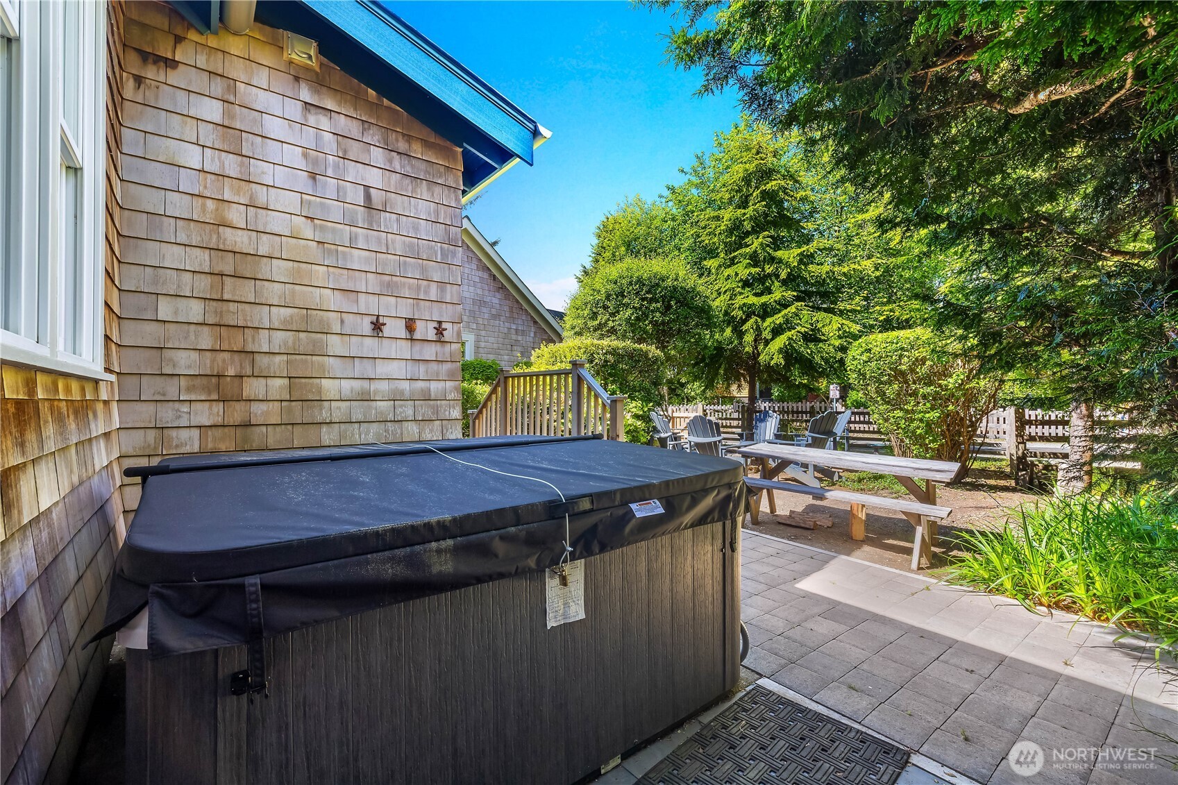 34 Seastar Lane Pacific Beach, WA 98571 - Photo 22 of 28 a backyard of a house with barbeque oven table and chairs