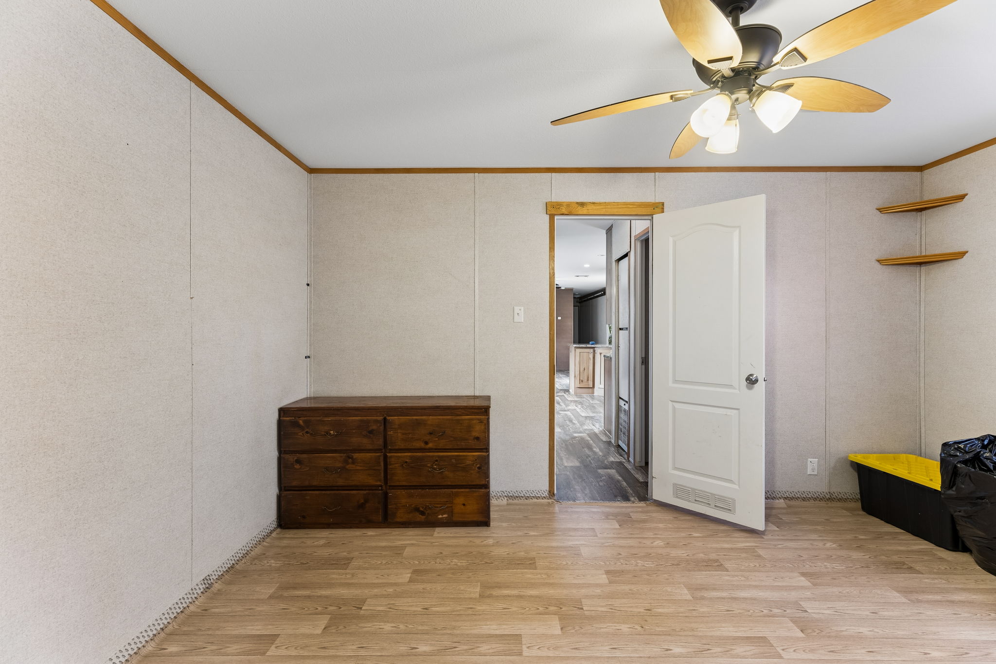 253 North County Line Road, Unit C Elgin, TX 78621 - Photo 15 of 39 A quiet bedroom with light wood flooring and a refreshing ceiling fan.