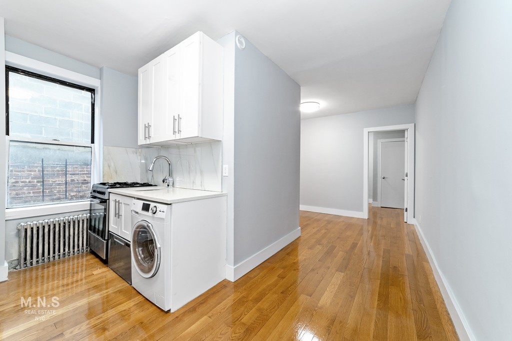 a utility room with cabinets washer and dryer
