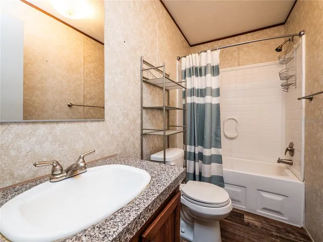 a bathroom with a toilet sink and shower